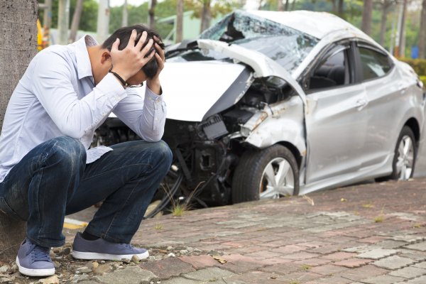Guy in front of accident clutching his head